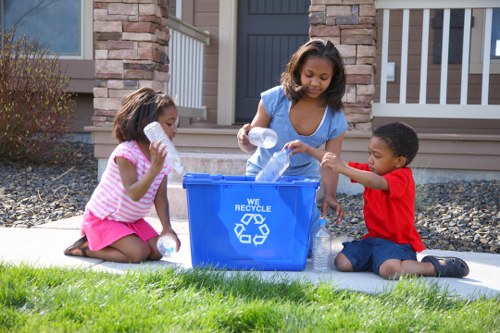Workers handling boxed household items for rubbish removal